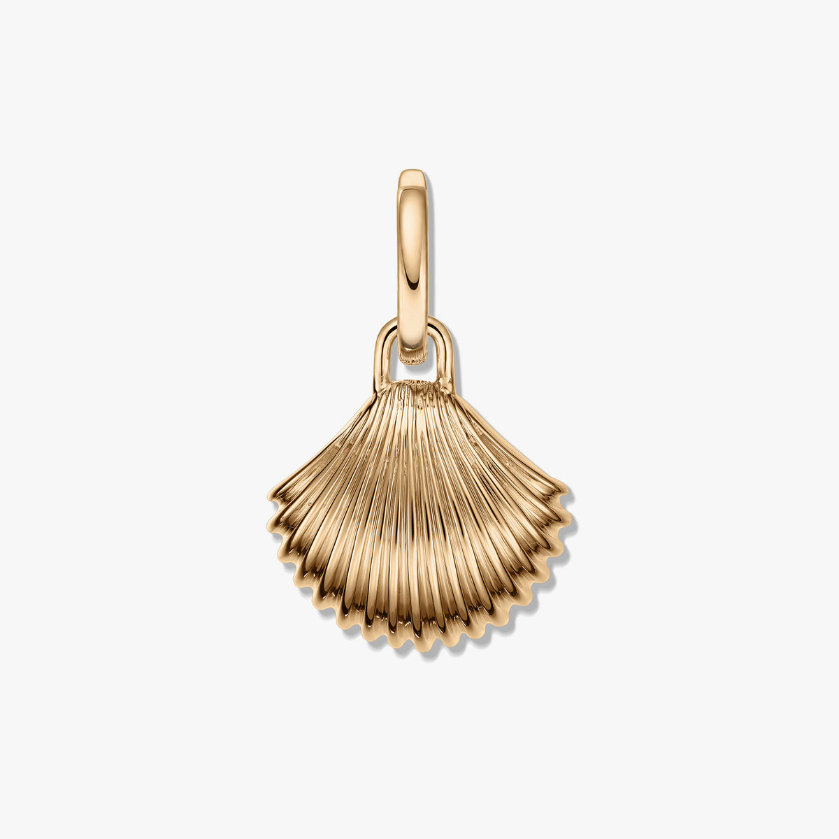 Golden shell-shaped pendant with ribbed texture and a polished gold-tone finish on a white background.