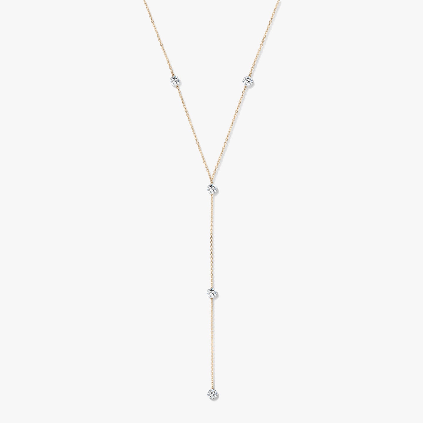 14K yellow gold diamond lariat necklace with five bezel-set round diamonds on a white background.