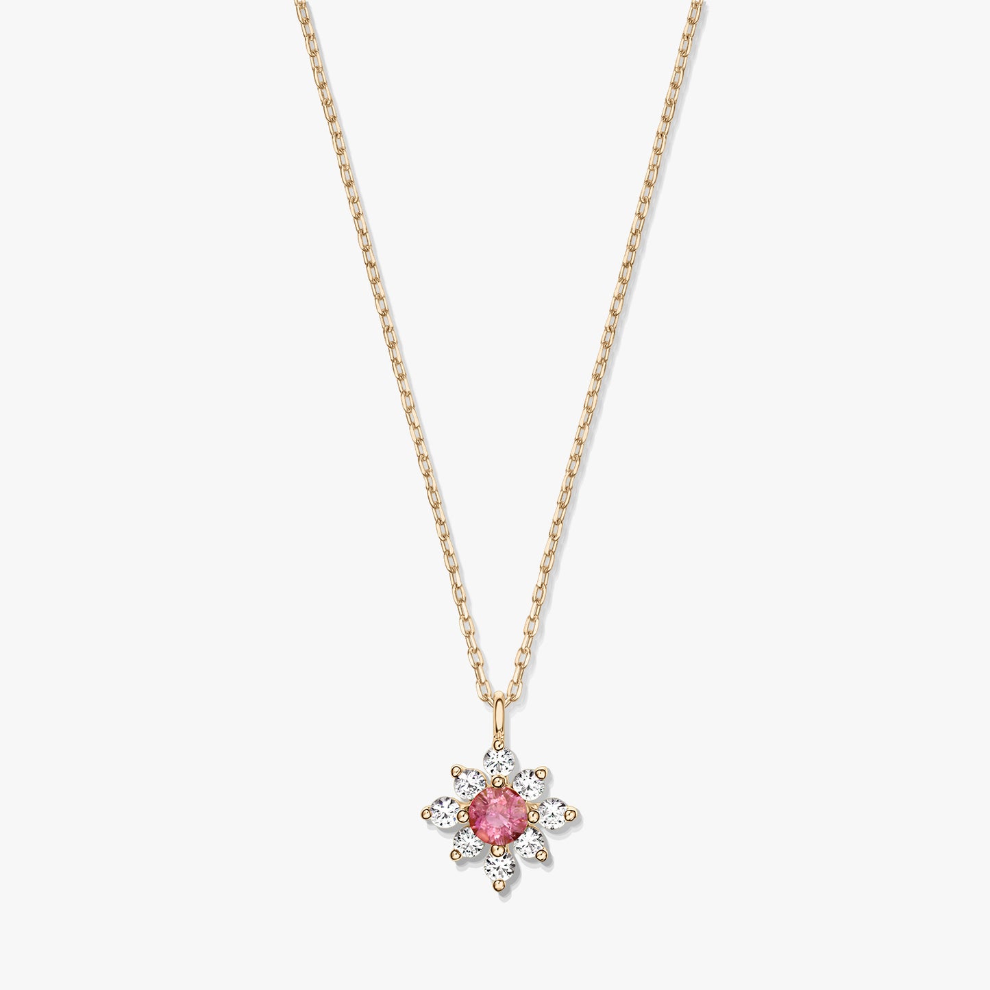 Elegant 14K gold necklace with a floral pendant featuring a pink tourmaline center haloed by white sapphires on a white background.