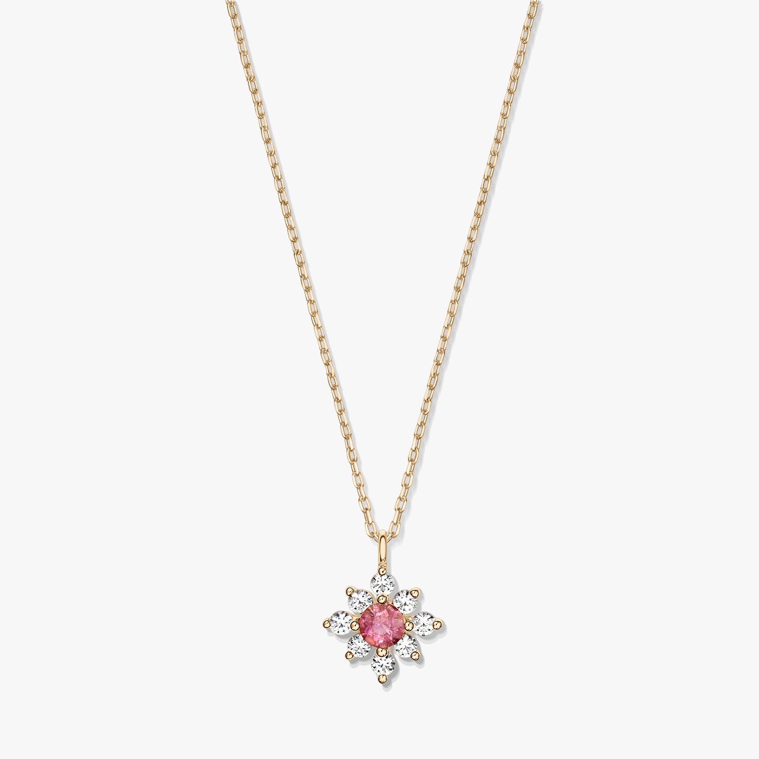 Elegant 14K gold necklace with a floral pendant featuring a pink tourmaline center haloed by white sapphires on a white background.