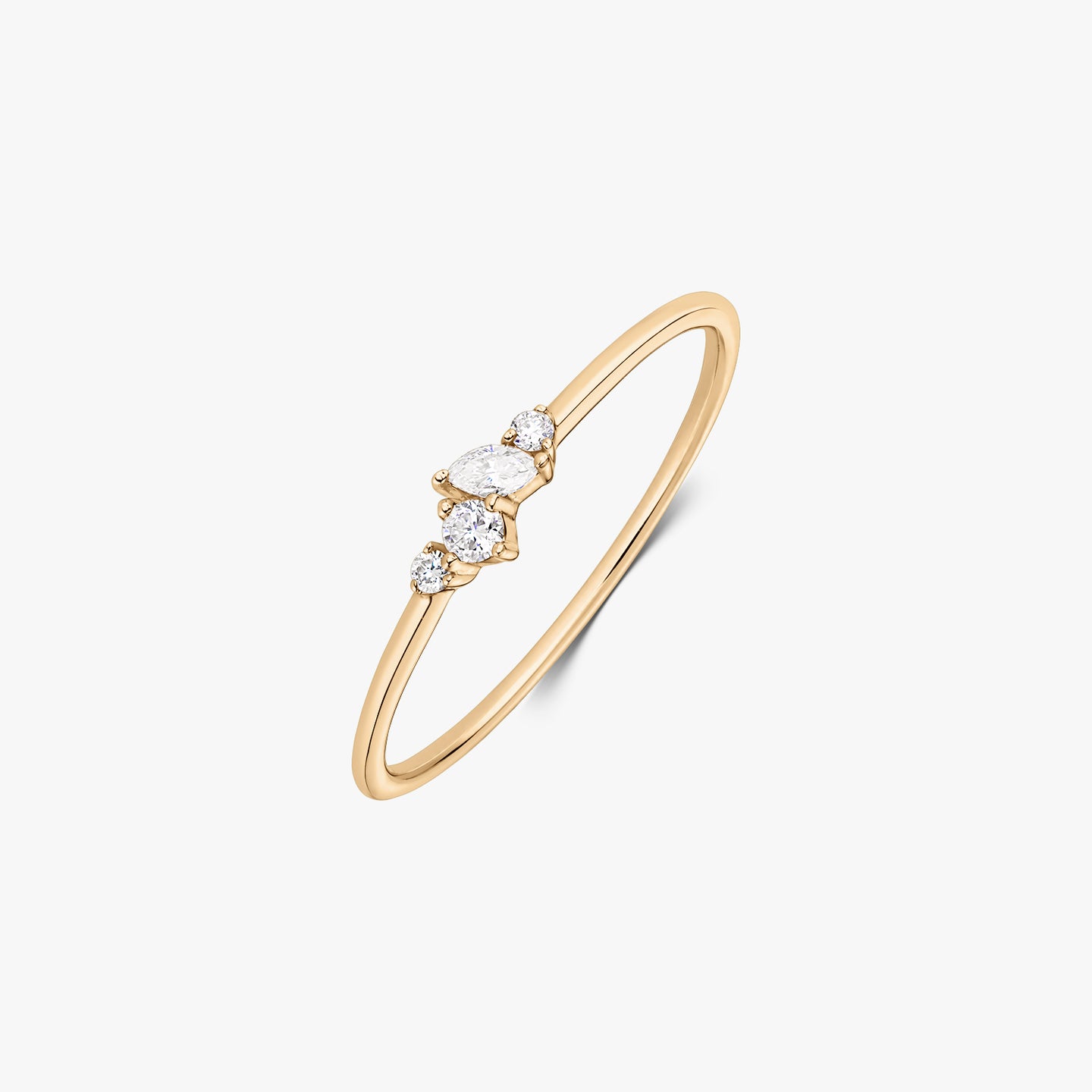 Nova 14K yellow gold ring featuring a delicate cluster of five white diamonds on a slim band, shown on a white background.