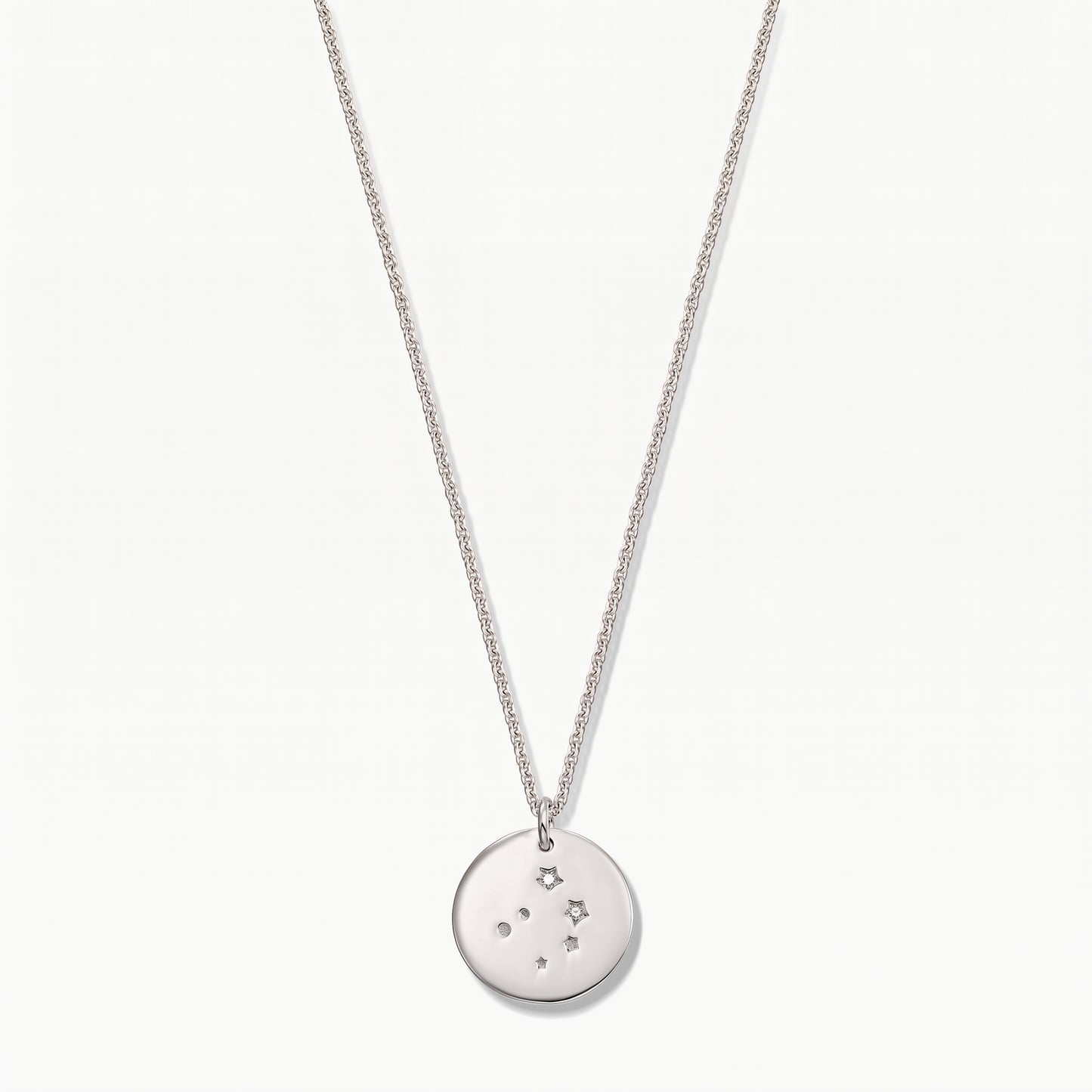 Sterling silver Libra zodiac coin necklace with white sapphire accents on a delicate chain, photographed on a white background.
