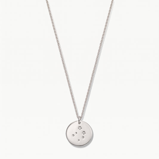 Sterling silver Libra zodiac coin necklace with white sapphire accents on a delicate chain, photographed on a white background.