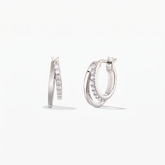Pair of Siamese silver double-hoop earrings with pavé zirconia on a white background.