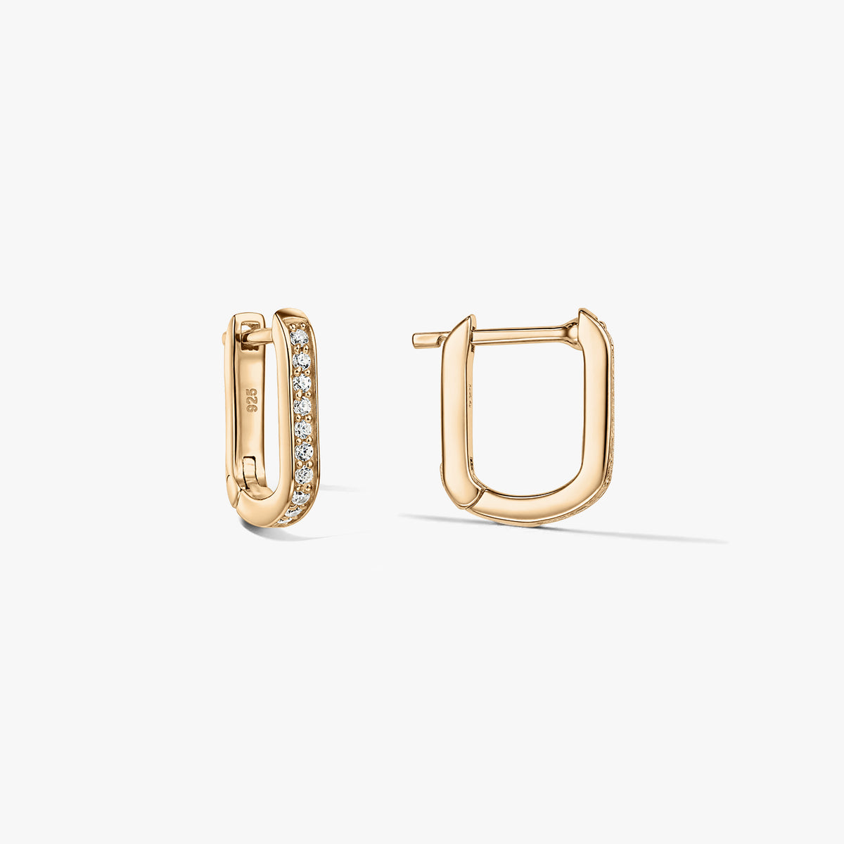 Pair of gold-tone U-shaped huggie hoop earrings in 925 silver with pavé clear zirconia, displayed against a white background with one earring open and the other closed.