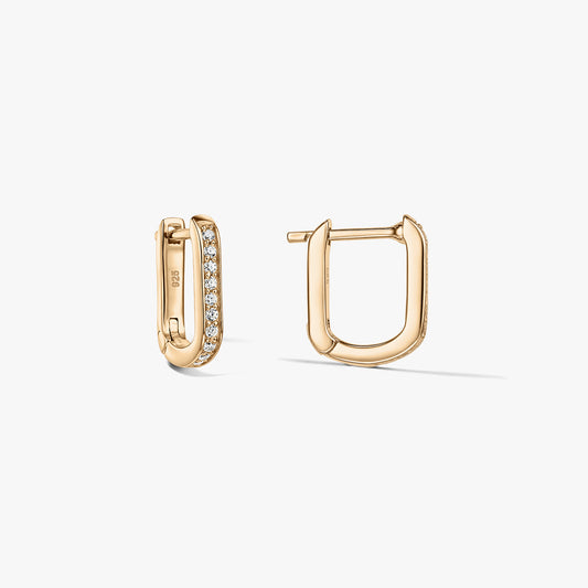 Pair of gold-tone U-shaped huggie hoop earrings in 925 silver with pavé clear zirconia, displayed against a white background with one earring open and the other closed.