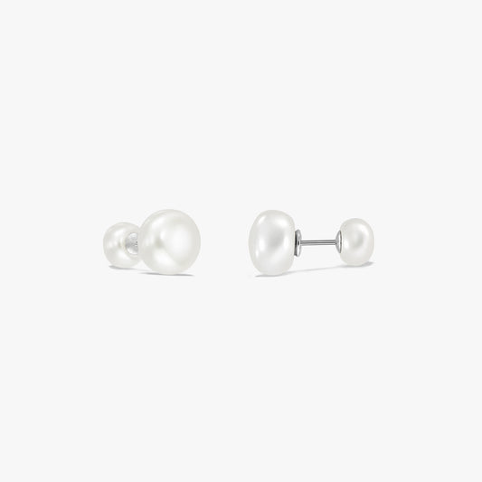 Elegant sterling silver double-pearl stud earrings on a white background, featuring a large natural white pearl on one end and a smaller pearl on the other, connected by a post.