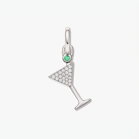 Silver cocktail glass pendant adorned with white zirconia pavé and a small green accent stone, displayed on a pristine white background.