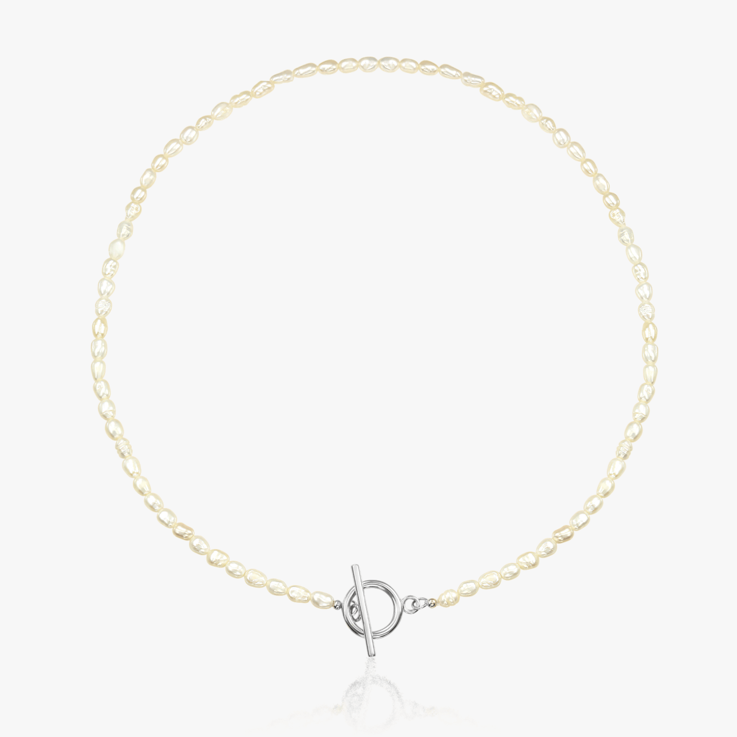 Silver necklace featuring natural pearls and a toggle clasp on a white background.