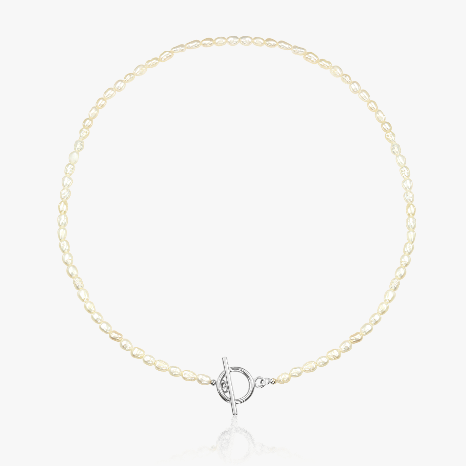 Silver necklace featuring natural pearls and a toggle clasp on a white background.