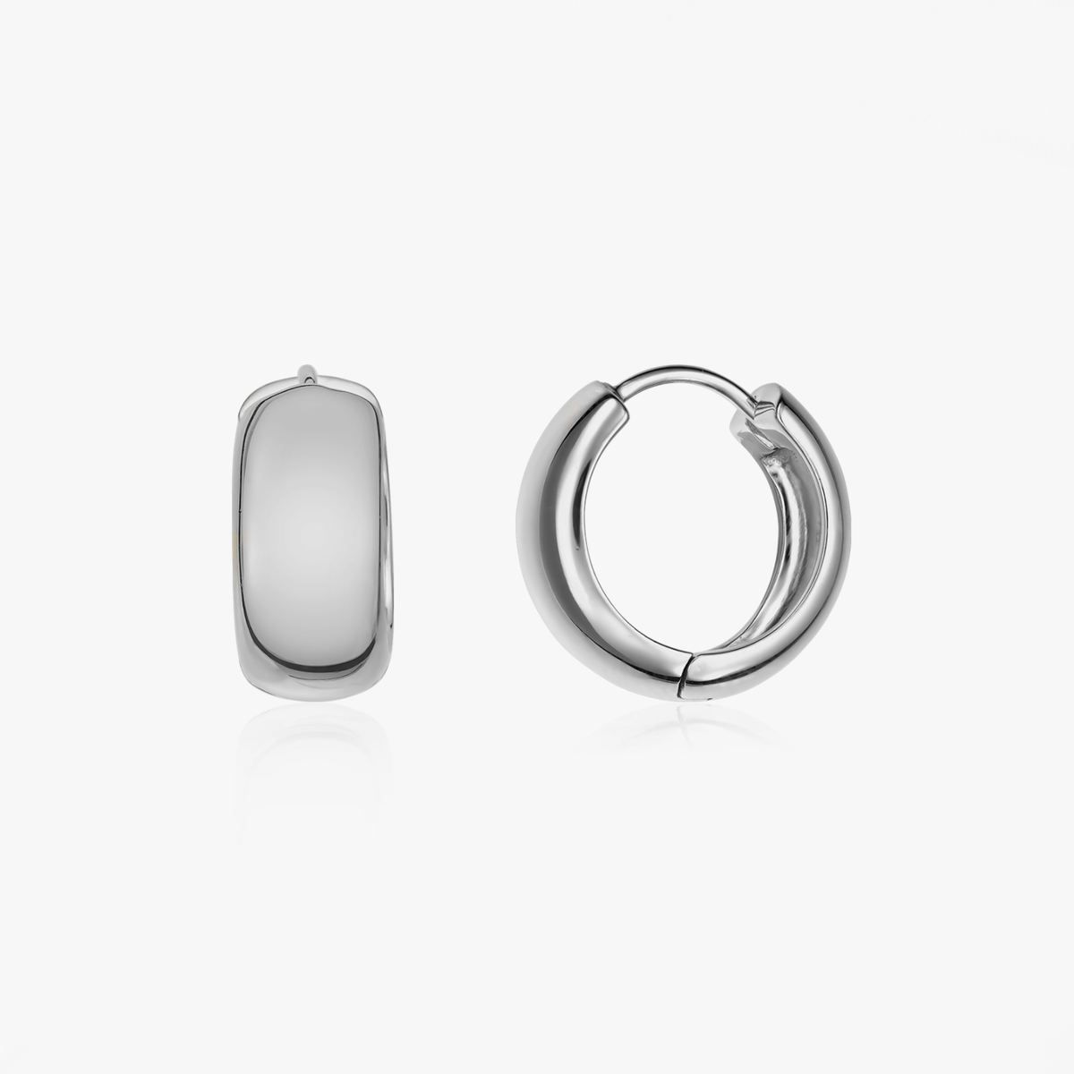 Pair of bold silver hoop earrings on a clean white background.