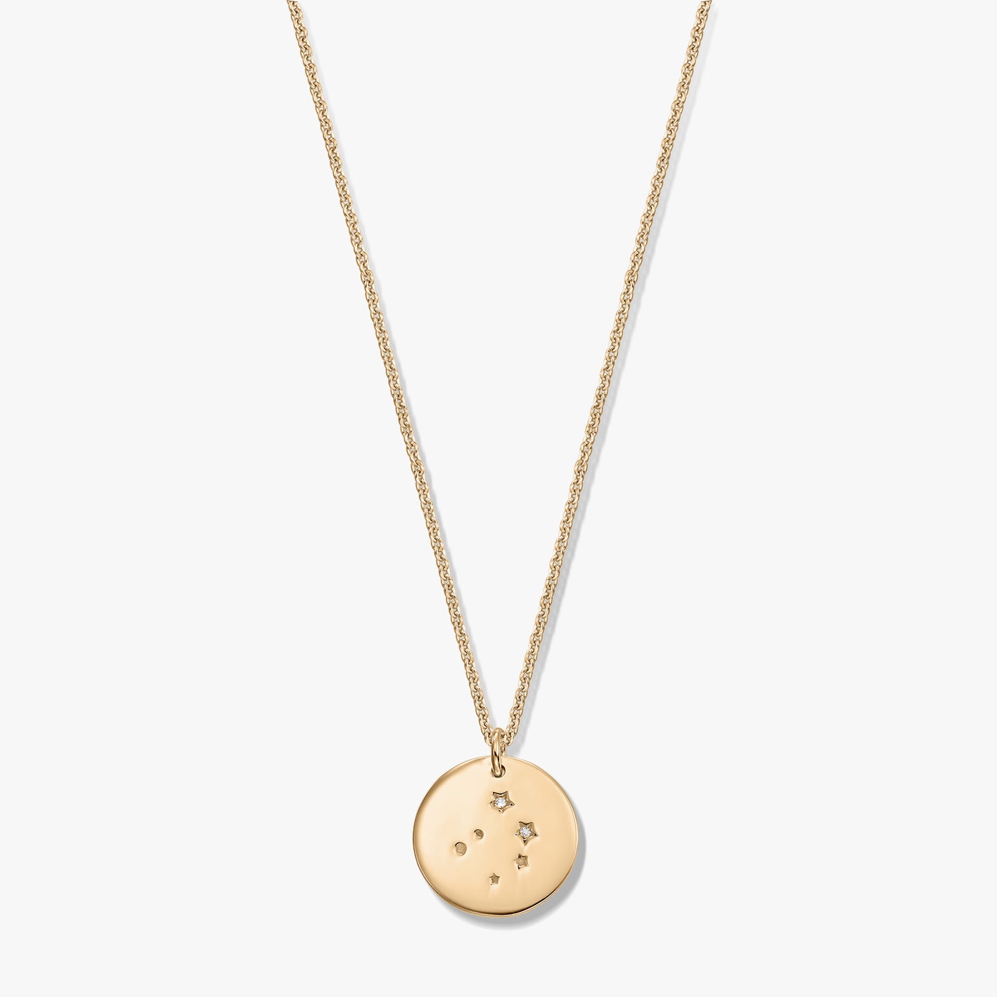 Gold‑tone Libra constellation disc pendant on a fine chain, photographed on a white background.
