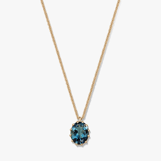 Delicate gold‑plated sterling silver necklace with an oval London blue topaz pendant on a white background.