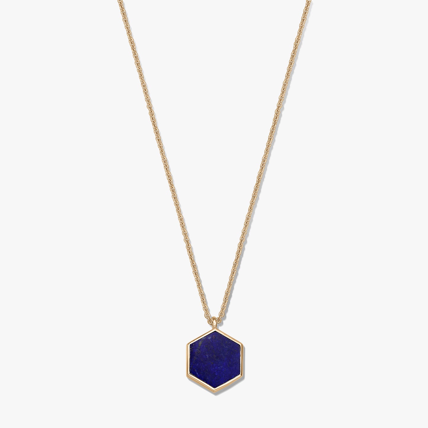 Gold-plated sterling silver necklace featuring a hexagonal lapis lazuli pendant on a white background.