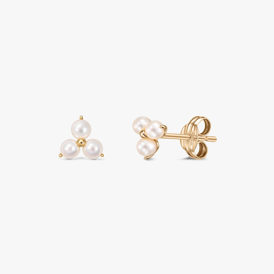 Pair of Pointe gold stud earrings featuring a cluster of three white cultured pearls arranged in a triangle, displayed front and side on a white background with butterfly backs.
