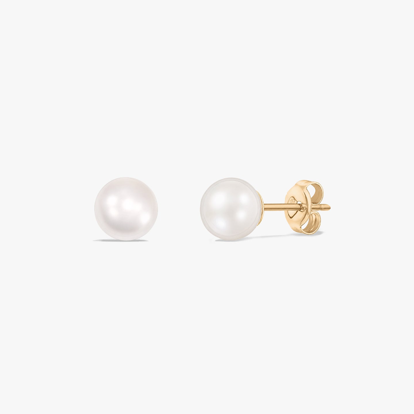 Pair of 14k yellow gold pearl stud earrings with butterfly backs on a white background.