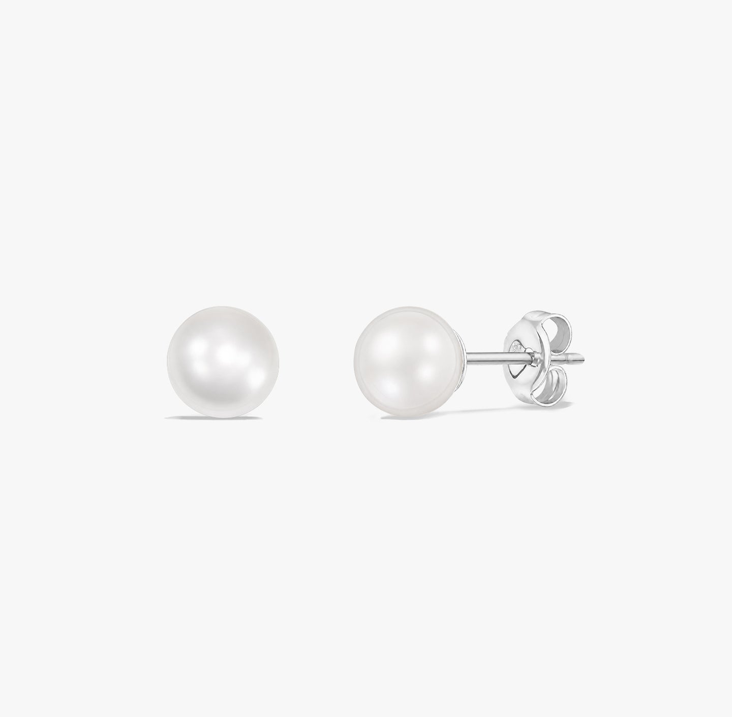 Timeless pearl stud earrings featuring natural white pearls set in 925 sterling silver on a white background.