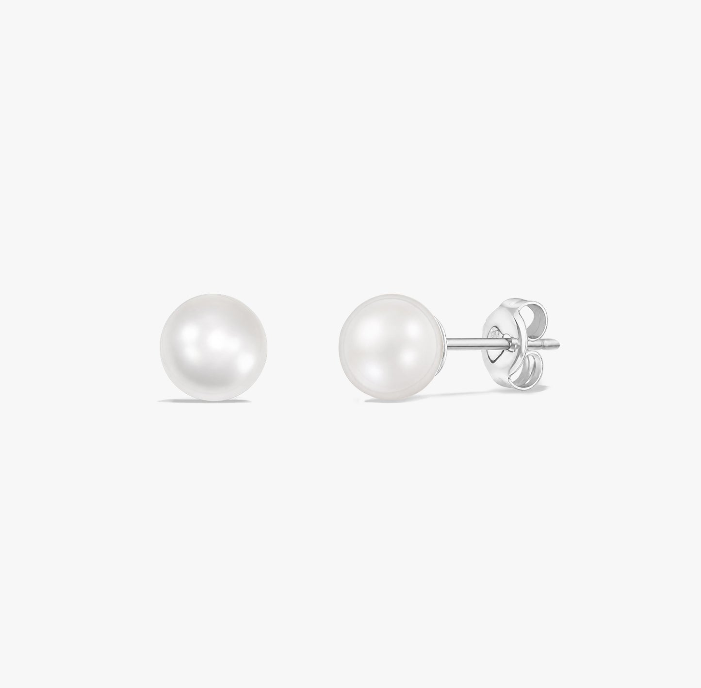 Timeless pearl stud earrings featuring natural white pearls set in 925 sterling silver on a white background.
