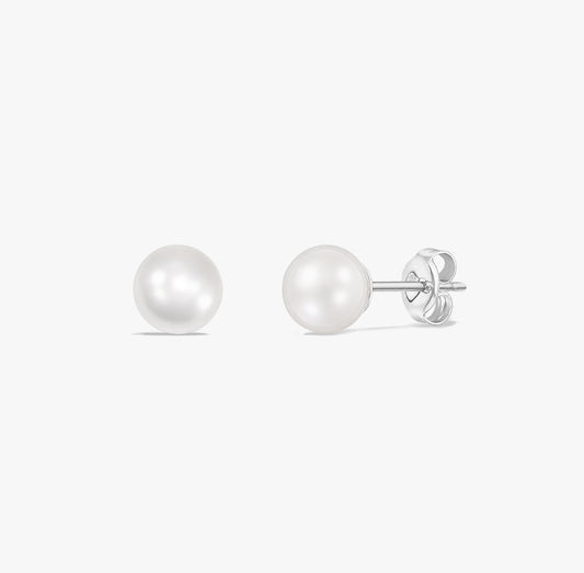Timeless pearl stud earrings featuring natural white pearls set in 925 sterling silver on a white background.