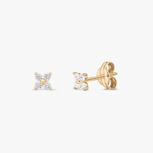 Pair of 14K yellow gold stud earrings with four clear zirconia stones arranged in a petite flower, shown from the front and side on a white background.