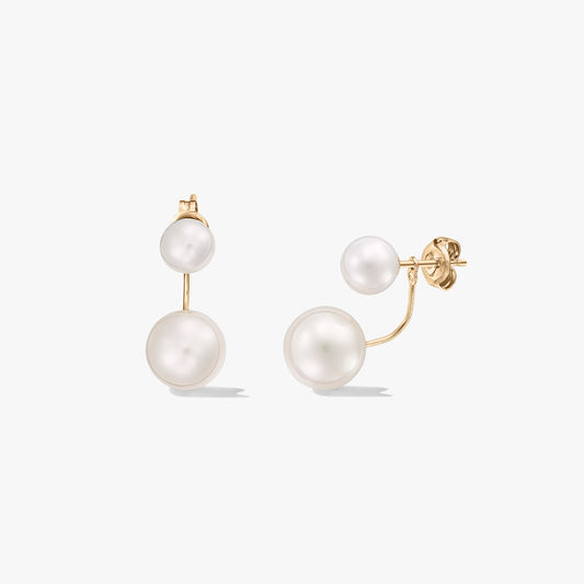 Square product image of 18K yellow gold ear-jacket stud earrings featuring double natural white pearls on a white background.