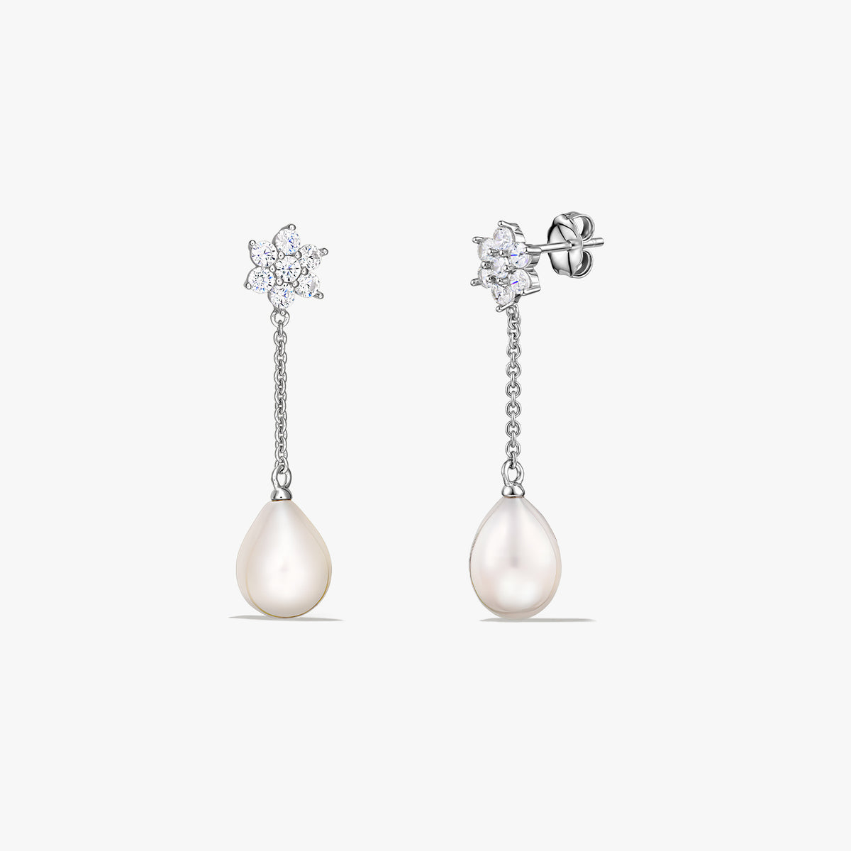 Pair of sterling silver drop earrings featuring teardrop-shaped cultured pearls suspended from a short chain, with a small sparkling cluster at the stud, on a white background.