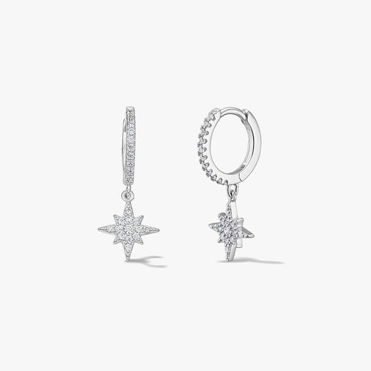 Pair of sterling silver hoop earrings with North Star pavé zirconia charms on a white background.