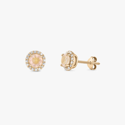 Pair of gold‑plated sterling silver stud earrings with a round rose quartz center and a halo of clear zirconia on a white background.