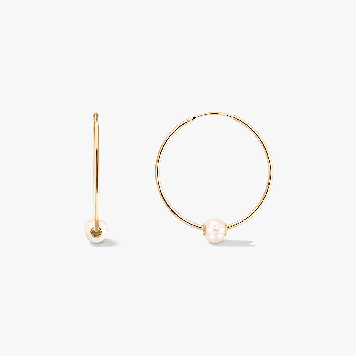 Golden Ines silver hoop earrings with cultured pearls, displayed front and side on a white background.