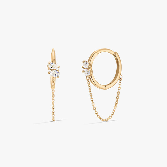 Elegant gold hoop earrings with zirconia stones and chain detail on a white background.