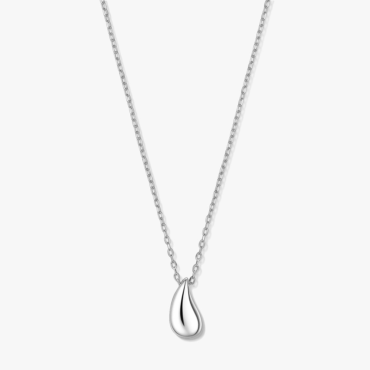Elegant silver teardrop pendant necklace on a fine chain, photographed on a white background.