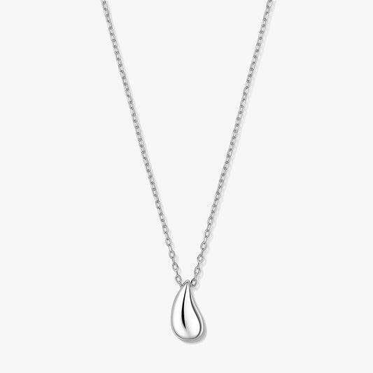 Elegant silver teardrop pendant necklace on a fine chain, photographed on a white background.