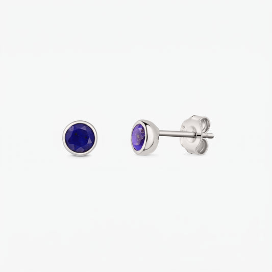 Sterling silver stud earrings featuring round faceted lapis lazuli stones; one earring shown from the front and the other from the side with butterfly back on a white background.
