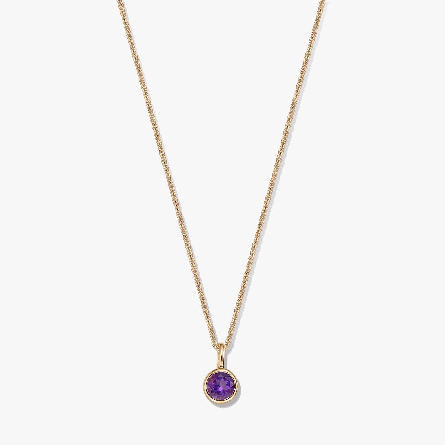 Gold-plated sterling silver necklace with a small round amethyst birthstone pendant on a white background.