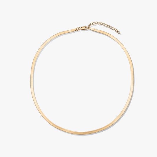 Golden herringbone necklace on a white background.