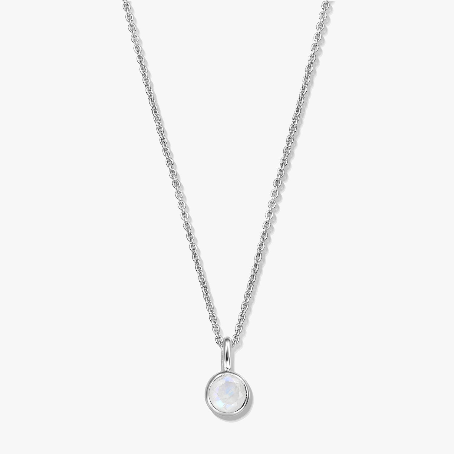Elegant sterling silver birthstone necklace featuring a round bezel-set moonstone pendant on a fine chain, photographed on a white background.