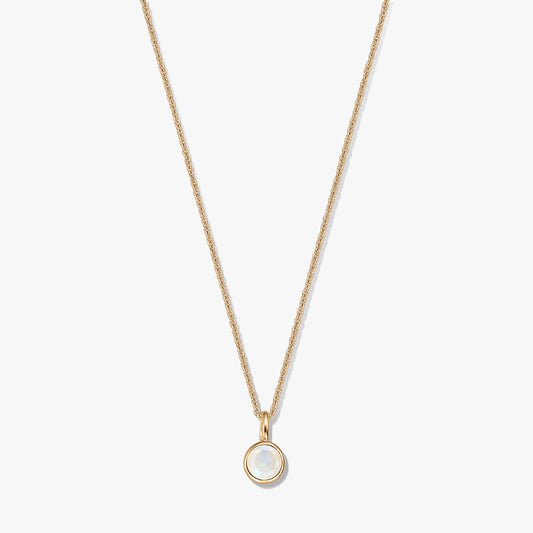 Gold-plated sterling silver necklace with a small round bezel-set moonstone birthstone pendant, centered on a white background.