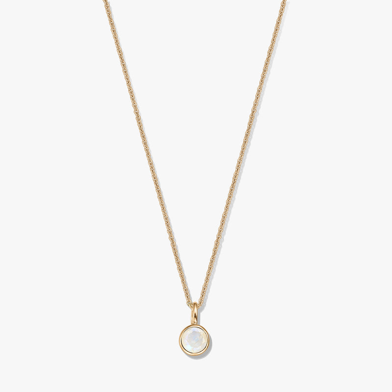 Gold-plated sterling silver necklace with a small round bezel-set moonstone birthstone pendant, centered on a white background.