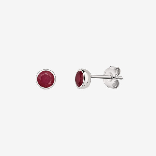 Pair of silver bezel-set ruby stud earrings displayed on a white background, shown from front and side views.