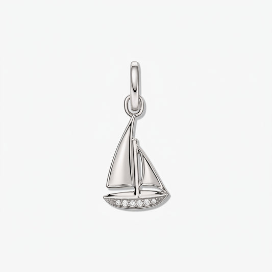 Sterling silver sailboat pendant with small white zirconia accents on a white background.