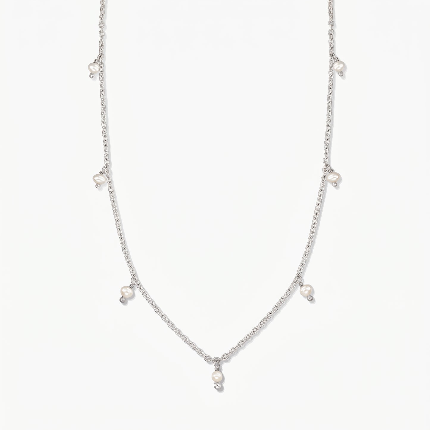 Indira Margot silver necklace with small natural pearl drops, photographed on a clean white background.