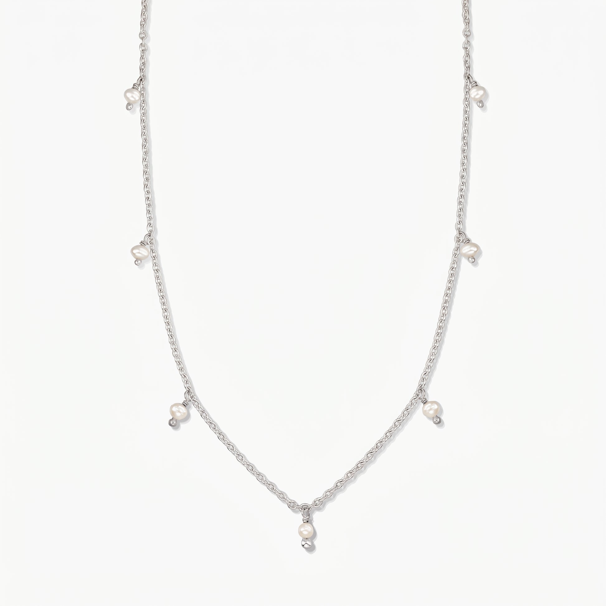 Indira Margot silver necklace with small natural pearl drops, photographed on a clean white background.