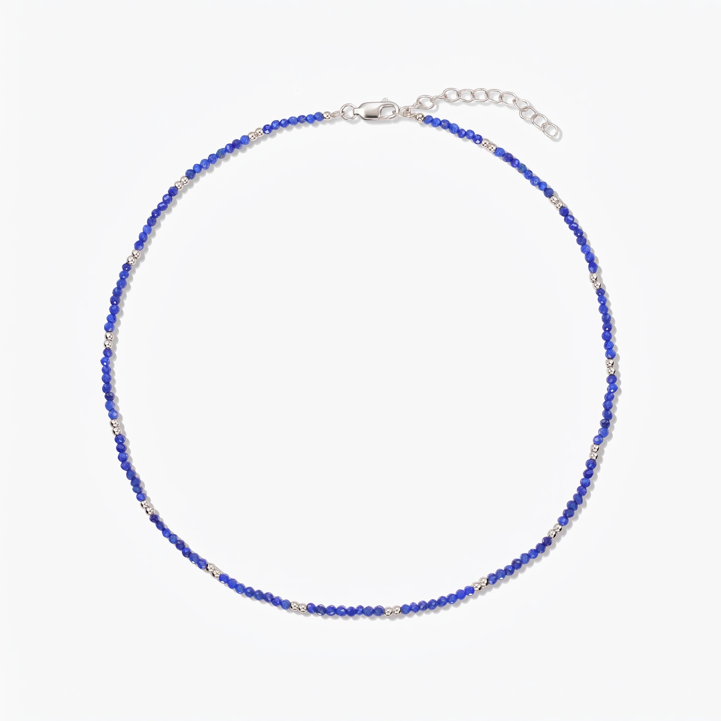 Indira SummerScape silver necklace with blue lapis lazuli beads, lobster clasp, and extender chain on a white background.