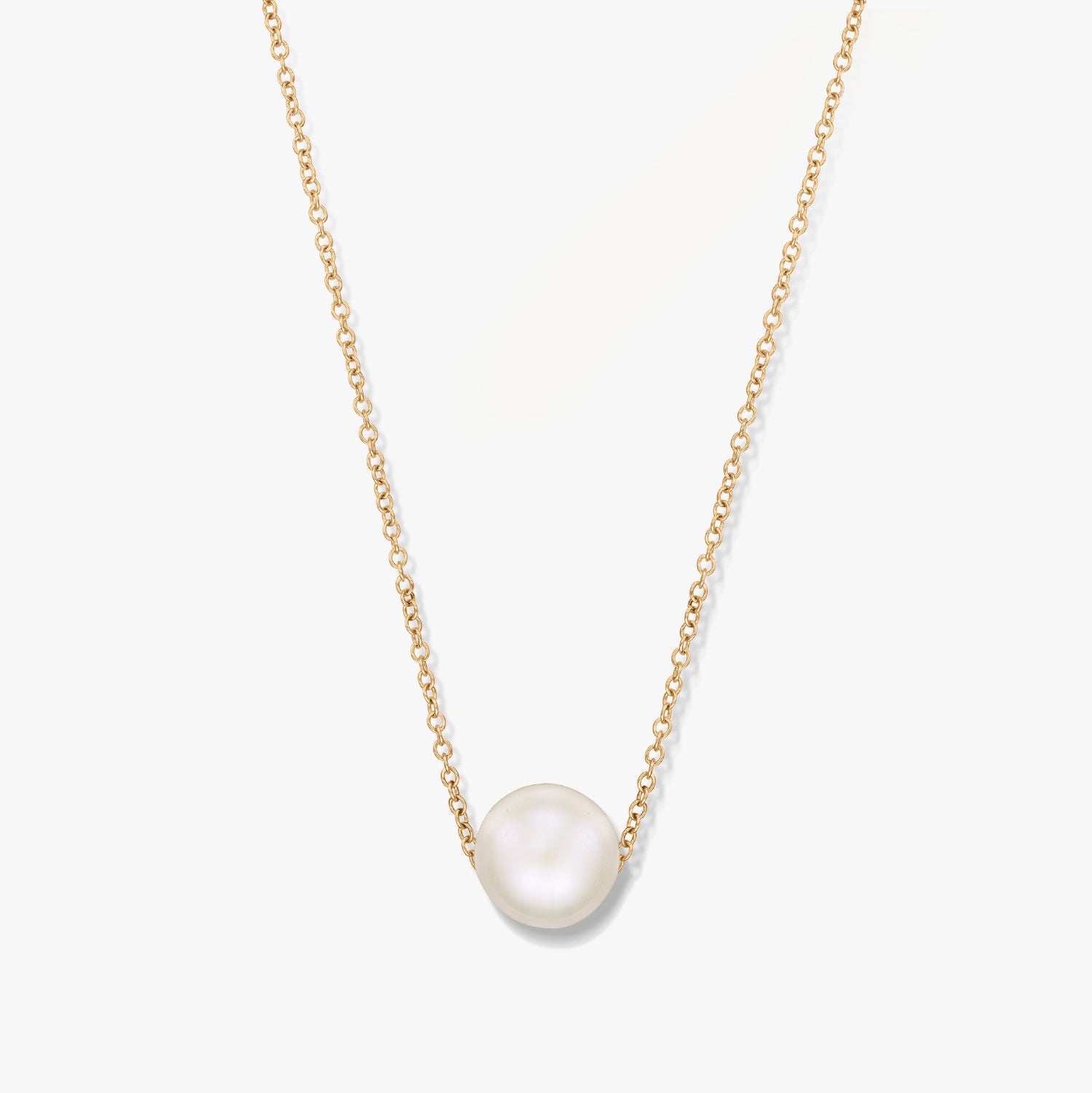 A gold necklace with a single pearl pendant on a white background.