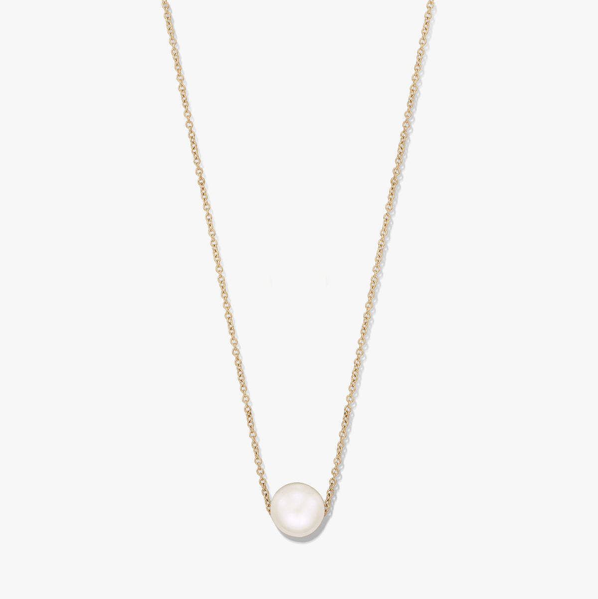 Elegant gold‑tone chain necklace featuring a single natural white pearl centered on the chain, isolated on a white background.