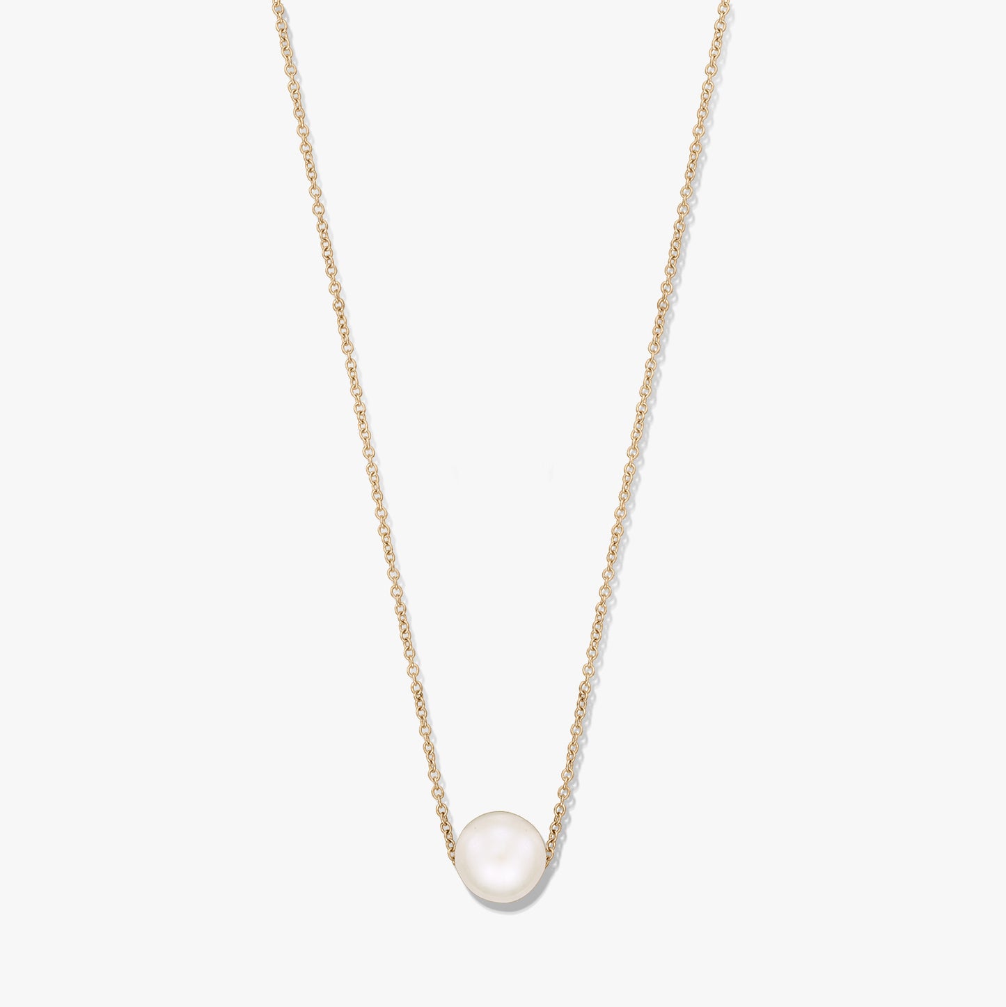 Elegant gold‑tone chain necklace featuring a single natural white pearl centered on the chain, isolated on a white background.