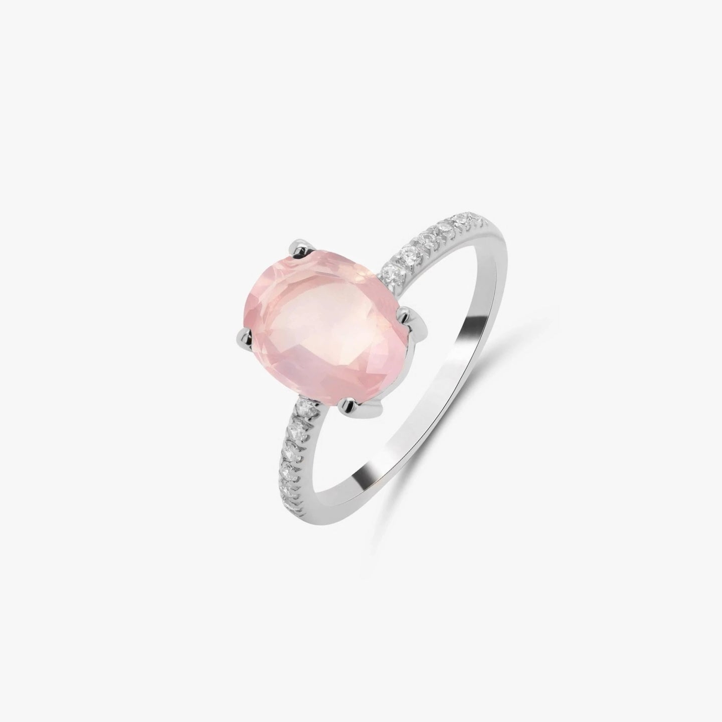 Silver ring featuring a rose quartz gemstone and small zirconia stones on a white background.